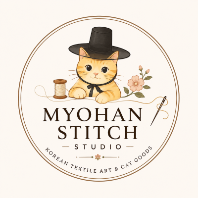 Official logo of Myohan Stitch Studio, a textile brand that reinterprets Korean traditional culture through original cat characters.