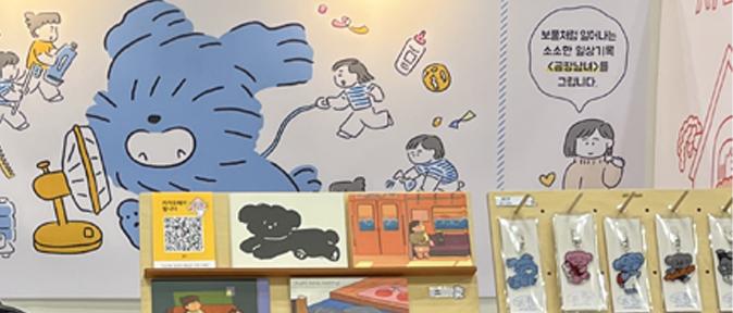 This image shows examples of DANI being used in an exhibition banner at a webtoon fair, as well as in physical merchandise such as keyrings. It demonstrates the character’s adaptability to offline exhibitions and product development, showcasing its potential as a versatile character IP.