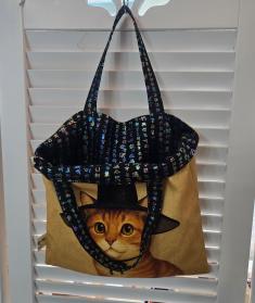 A double-sided canvas tote bag featuring the Gat Cat character and Hunminjeongeum design, showcasing the commercialization of our original character IP into textile products.