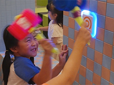 An action arcade game you play with your whole body—striking glowing targets in a maze with a dedicated hammer to compete for the high score.